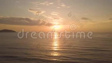 傍晚的金色日落，越过海水，无人驾驶的视野。 清晨美丽的日出，金色的阳光反射